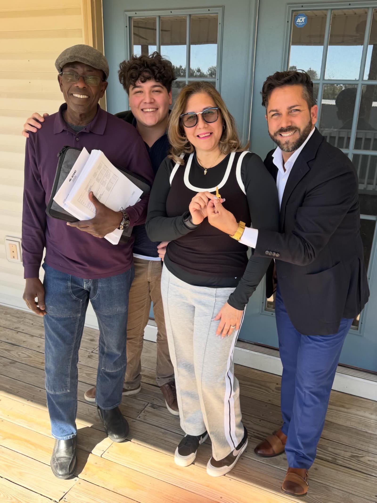 Happy buyers receiving their keys with Yunior Estevez, Tampa realtor
